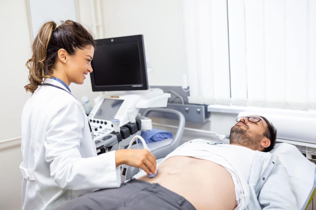 Image of a diagnostic medical sonographer conducting abdominal diagnostics